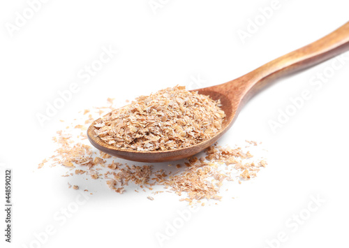 Wooden spoon with wheat bran on white background