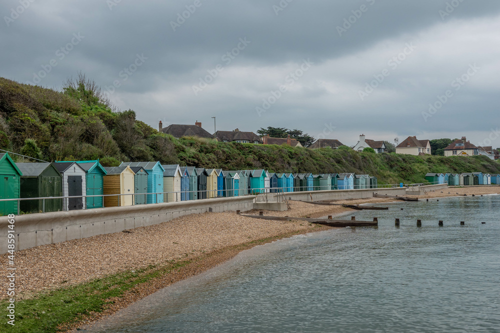 beach huts along the water front by the sea in Hill Head Hampshire England beach huts along the water front by the sea in Hill Head Hampshire England