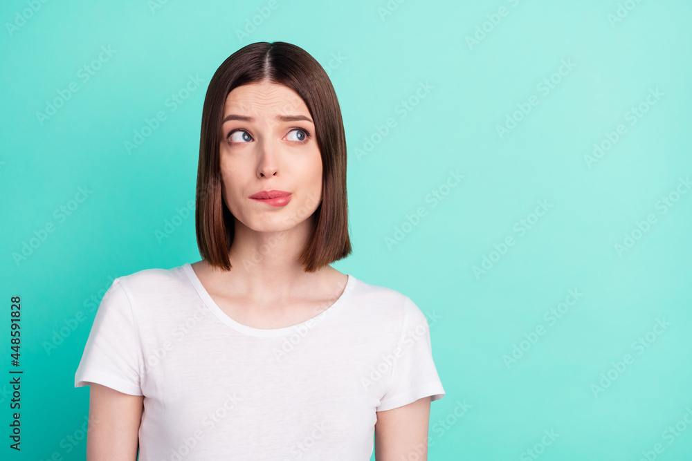 Portrait of attractive worried miserable girl overthinking copy space isolated over bright teal turquoise color background Portrait of attractive worried miserable girl overthinking copy space isolated over bright teal turquoise color background