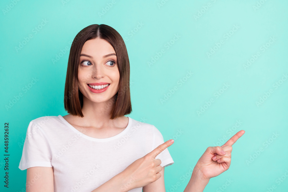 Portrait of attractive cheerful girl demonstrating copy empty space ad advert isolated over bright teal turquoise color background Portrait of attractive cheerful girl demonstrating copy empty space ad advert isolated over bright teal turquoise color background