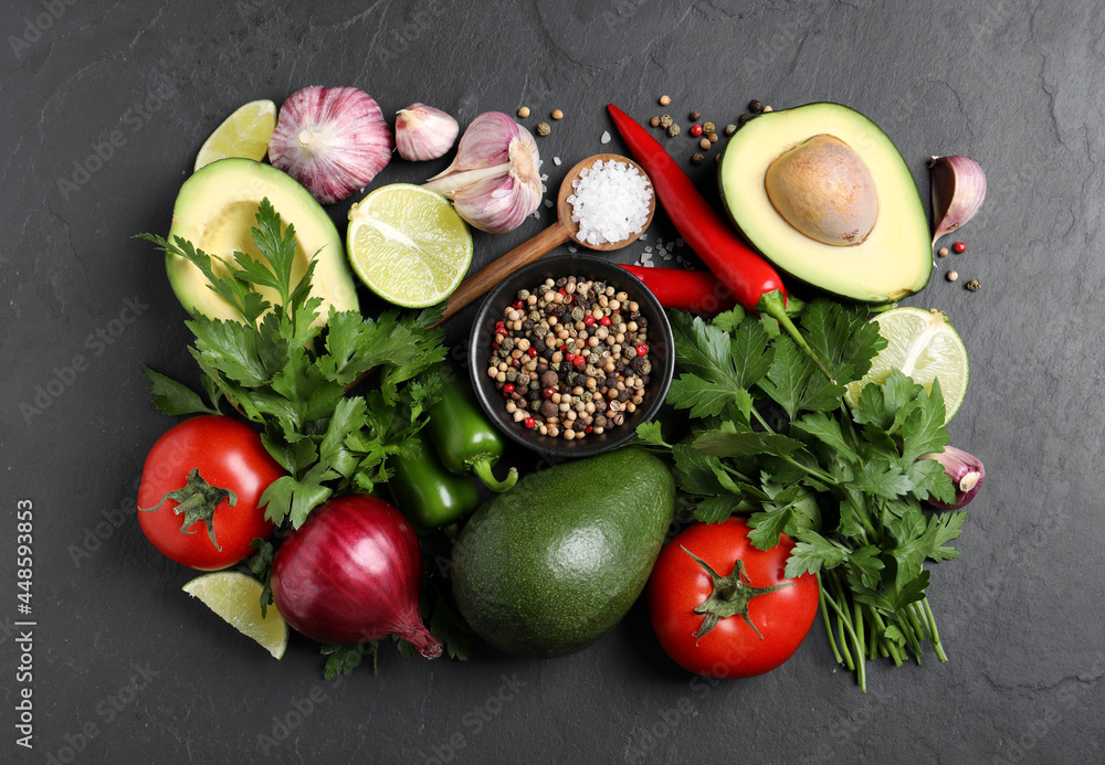 Fresh ingredients for guacamole on black table, flat lay