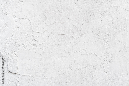 Texture of white painted wall, chipped, scratches. Stucco wall close-up