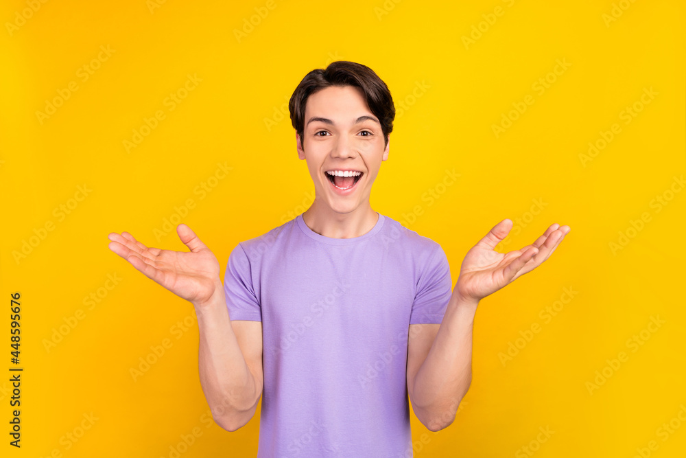 Photo of amazed funny nice guy open mouth wow reaction wear purple t-shirt isolated yellow color background Photo of amazed funny nice guy open mouth wow reaction wear purple t-shirt isolated yellow color background