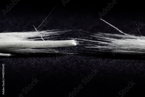 drastically broken real optical fiber on black background photo