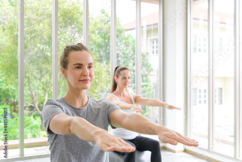 Caucasian women sitting and balancing on exercise ball. fitness, sport, training and people concept Free Download Caucasian women sitting and balancing on exercise ball. fitness, sport, training and people concept - GFXLoad