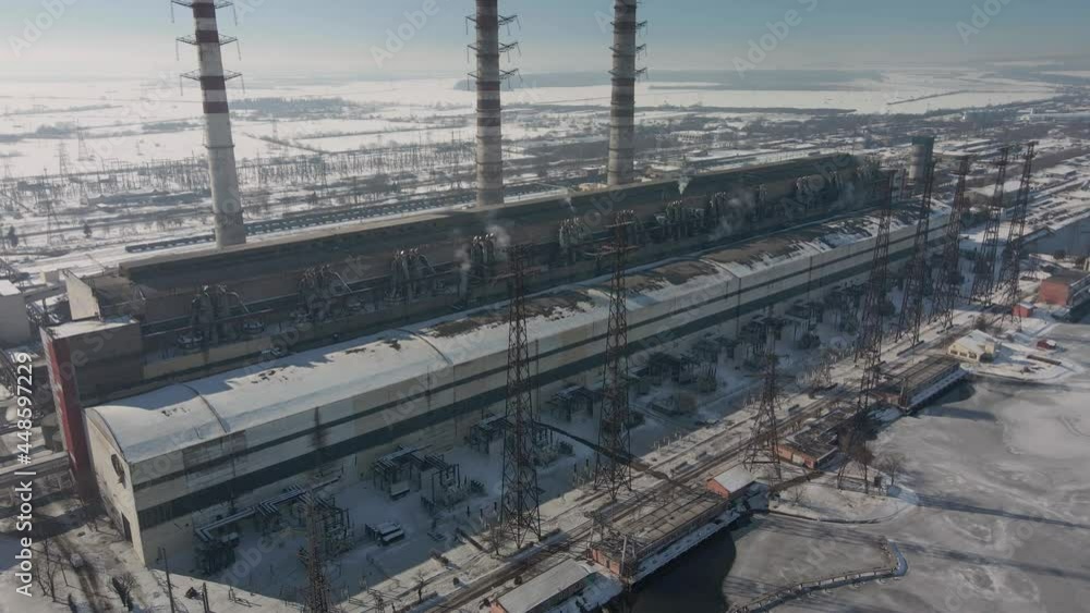 Aerial view of high chimney pipes with grey smoke from coal power plant. Production of electricity with fossil fuel. Aerial view of high chimney pipes with grey smoke from coal power plant. Production of electricity with fossil fuel.