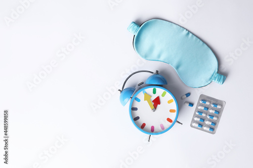 Wallpaper Mural Sleeping mask, pills and alarm clock on white background, flat lay. Insomnia treatment Torontodigital.ca
