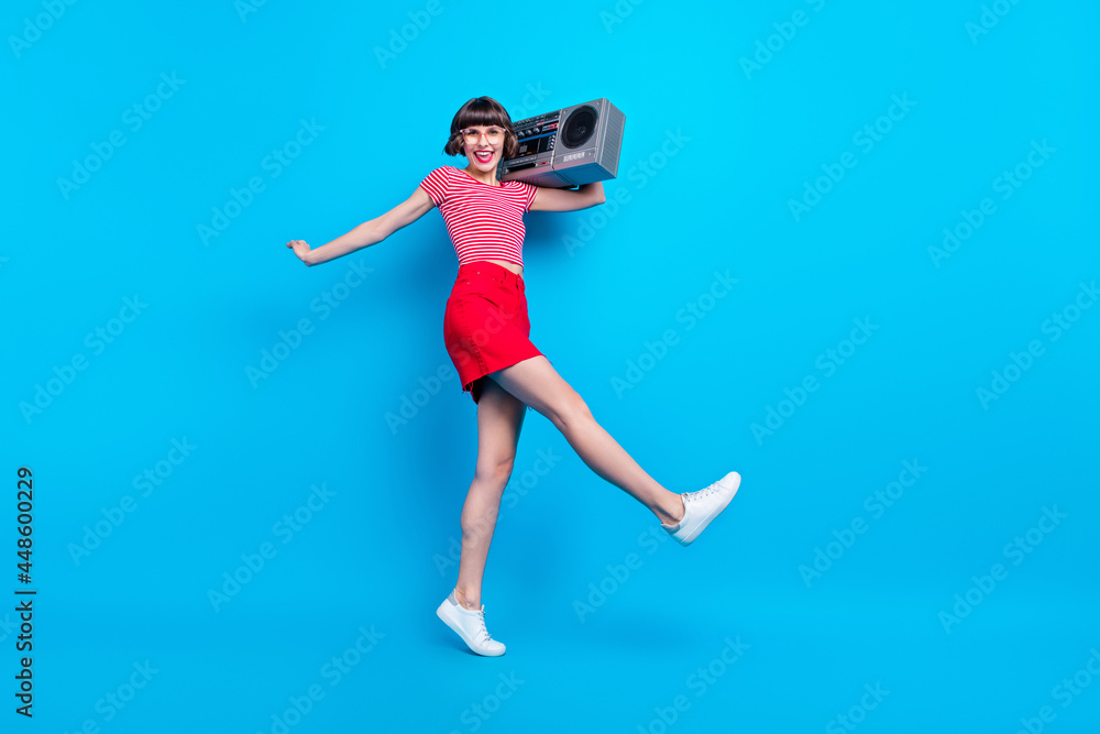 Full length body size photo dancing girl keeping boom box isolated bright blue color background