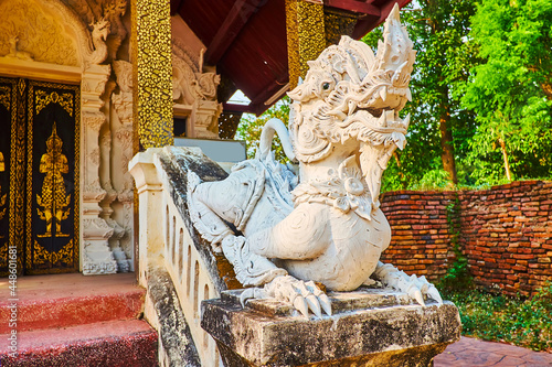 The Singha lion sculpture at the Viharn of Wat Pratu Pong, Lampang, Thailand photo