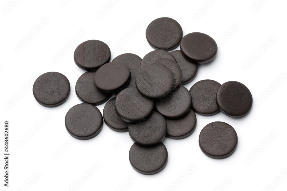 Heap of round black Bay Leaf Licorice isolated on white background Heap of round black Bay Leaf Licorice isolated on white background