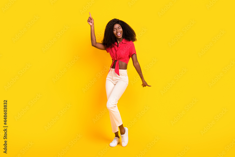 Full body photo of attractive happy nice dark skin lady good mood dance isolated on yellow color background Full body photo of attractive happy nice dark skin lady good mood dance isolated on yellow color background