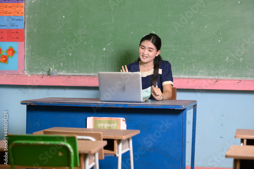 Female young hispanic school math teacher, college tutor coach looking at webcam and talking in classroom giving virtual teaching remote class online lesson by zoom conference call on laptop computer.