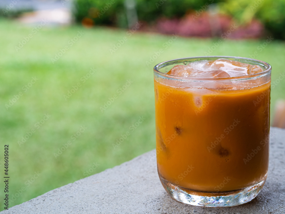 ice tea or ice thai tea in glass , fresh dessert in coffee cafe with nature background ice tea or ice thai tea in glass , fresh dessert in coffee cafe with nature background