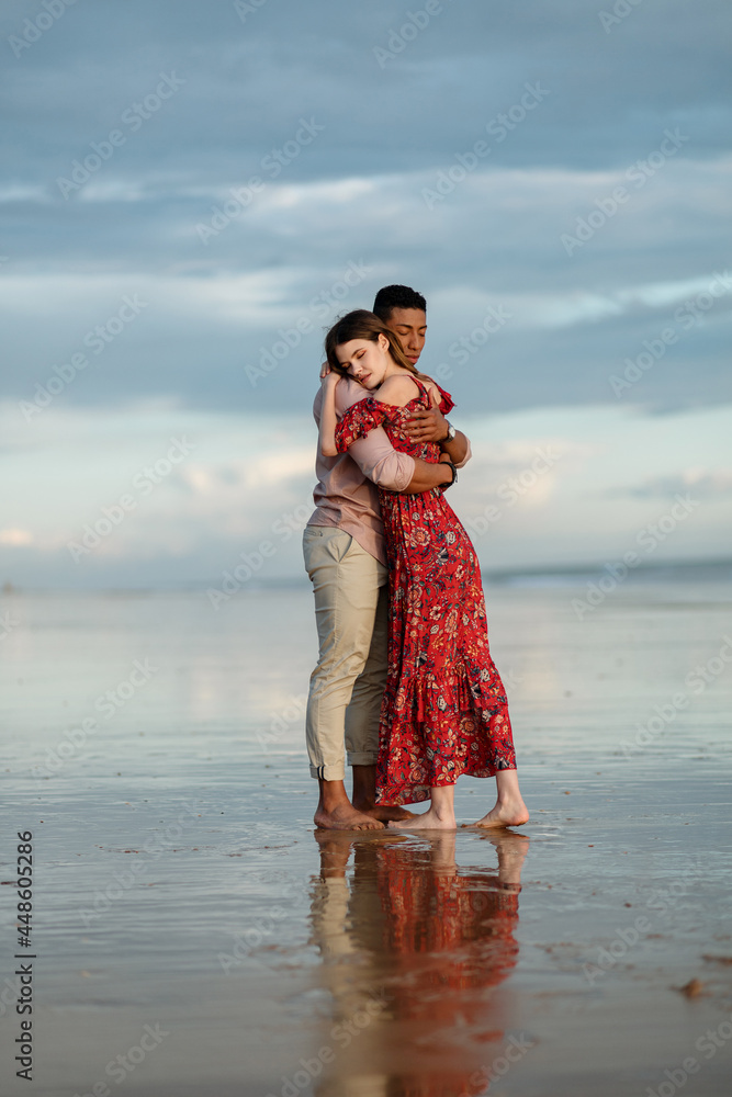 Tender multiethnic couple embracing on beach Tender multiethnic couple embracing on beach