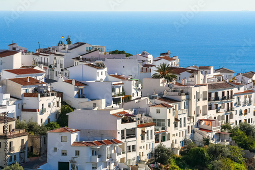 Andalusian white village on a hill and overlooking the blue sea in the background. Frigiliana Malaga. © josemiguelsangar