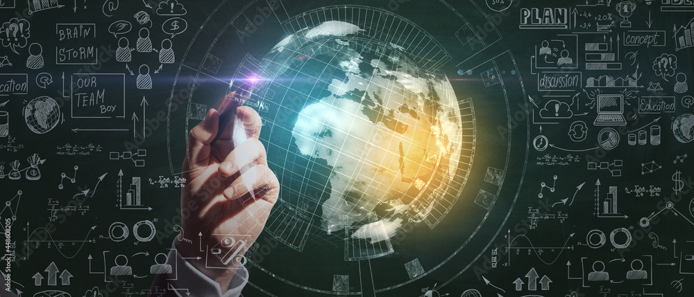 Fototapeta premium Businessman hand pointing at creative business sketch and globe hologram on chalkboard wall background. Success, seminar and workshop concept.