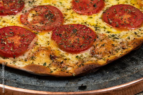 Neapolitan Brazilian pizza with mozzarella cheese and tomato slices with oregano