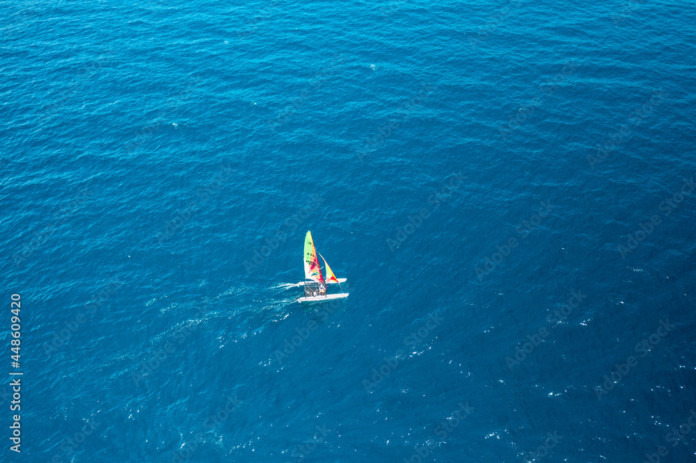 Aerial view of portable sailboat windsurfing catamaran in blue water of Adriatic Sea