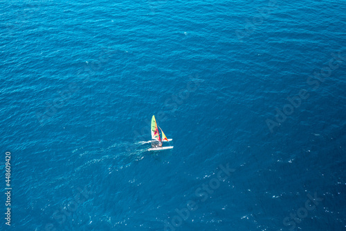 Aerial view of portable sailboat windsurfing catamaran in blue water of Adriatic Sea © vladim_ka