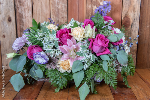 Beautiful bouquet of arranged roses, stargazers, chrysanthemums, and daisys in a long and full display of beauty