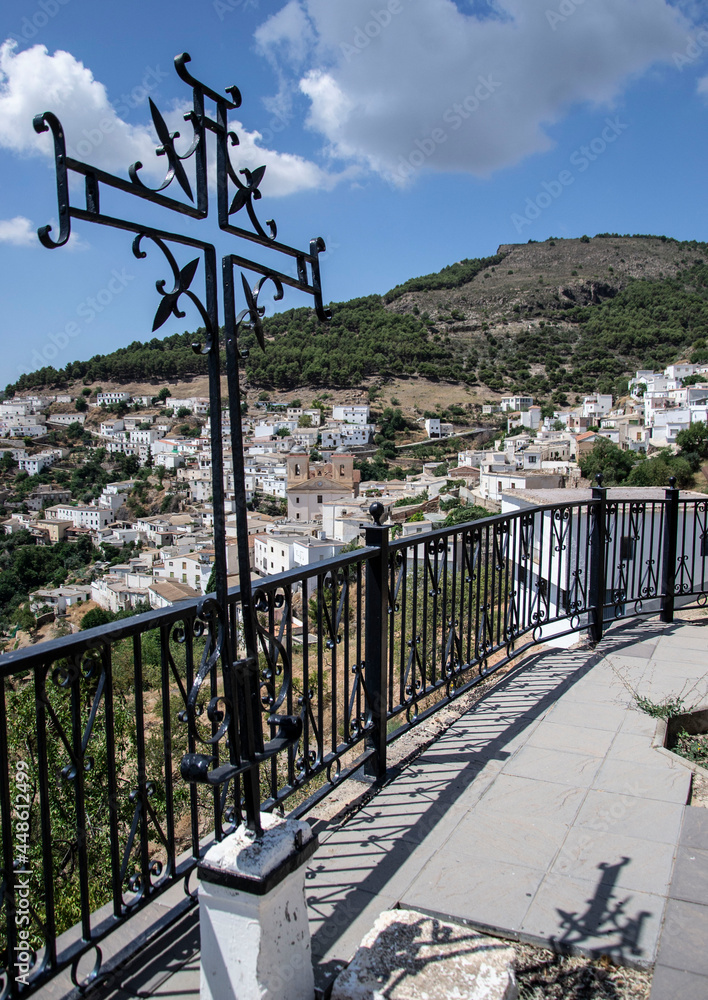 viewpoint of the town of Murtas of white houses on the mountain with a black iron cross