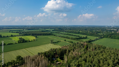 Land or landscape of green field in aerial view. Include agriculture farm  house building  village. That real estate or property. Plot of land for housing subdivision  development  sale or investment