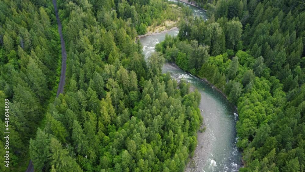 Top down view of winding river and railroad among the green forest in Canada Top down view of winding river and railroad among the green forest in Canada