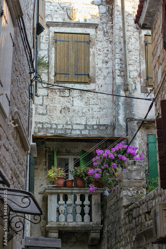 The balcony with the flower pots at the stone street of Trogir town, Trogir, Croatia