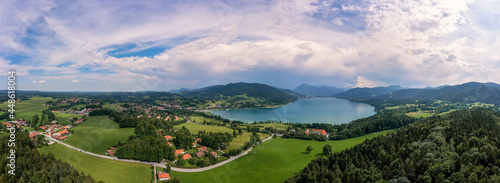Bavarian recreation area of the Tegernsee, the view at the alps from a high angle view of a drone at a beautiful summer day with the Gut Kaltenbrunn in the foreground.