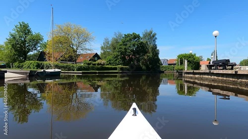 Canoeing through Uitwellingerga in Friesland, The Netherlands photo