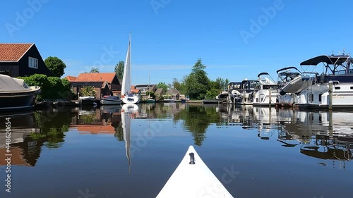 Canoeing through Uitwellingerga in Friesland, The Netherlands photo