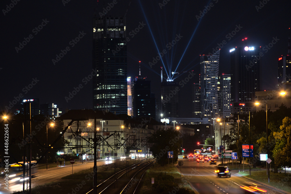 view of the center of warsaw at night, light show, completion of the construction of the skysawa skyscraper