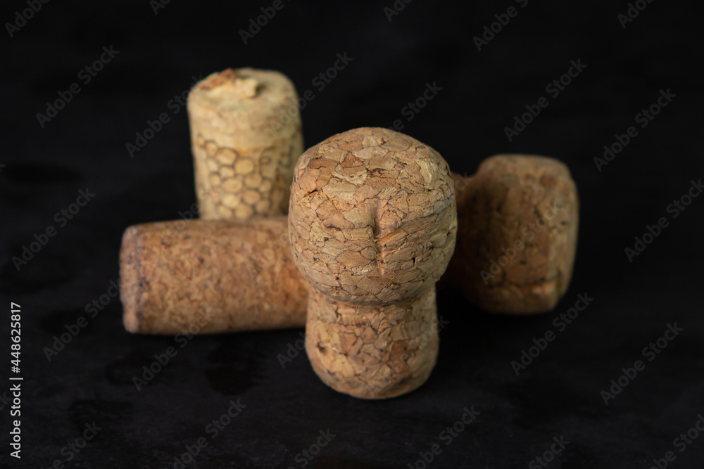 Wine and champagne corks on a dark background.