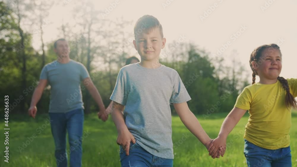 people in the park. happy family dream kid walk at sunset. mom dad and daughter baby walk holding hands in the park. happy family kid concept. parents and fun children. people walk in a green park people in the park. happy family dream kid walk at sunset. mom dad and daughter baby walk holding hands in the park. happy family kid concept. parents and fun children. people walk in a green park