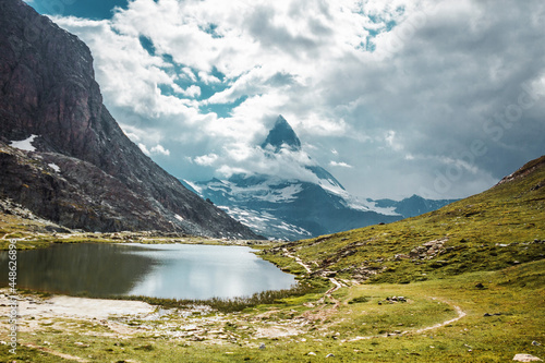 Matterhorn mountain in Swiss Alps. Clouds and lake in mountains. Zermatt, Switzerland.