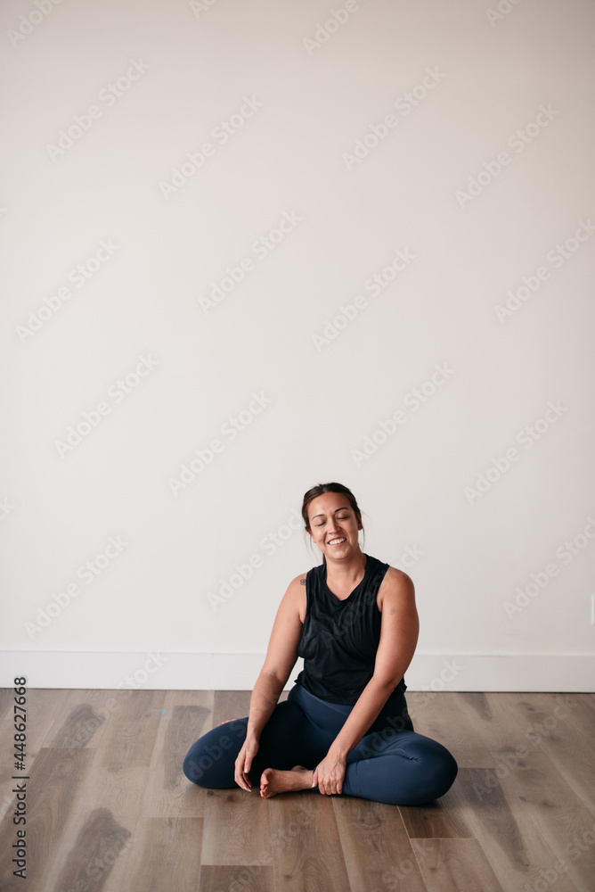 happy smiling woman practicing yoga relaxing in gym happy smiling woman practicing yoga relaxing in gym