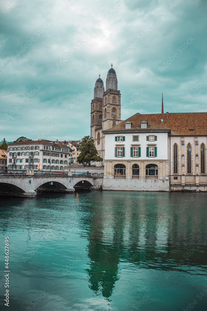 Old town in Zurich city, Switzerland. Panorama of river and embankment with historic buildings. Pleasure boat. Swiss vacation.