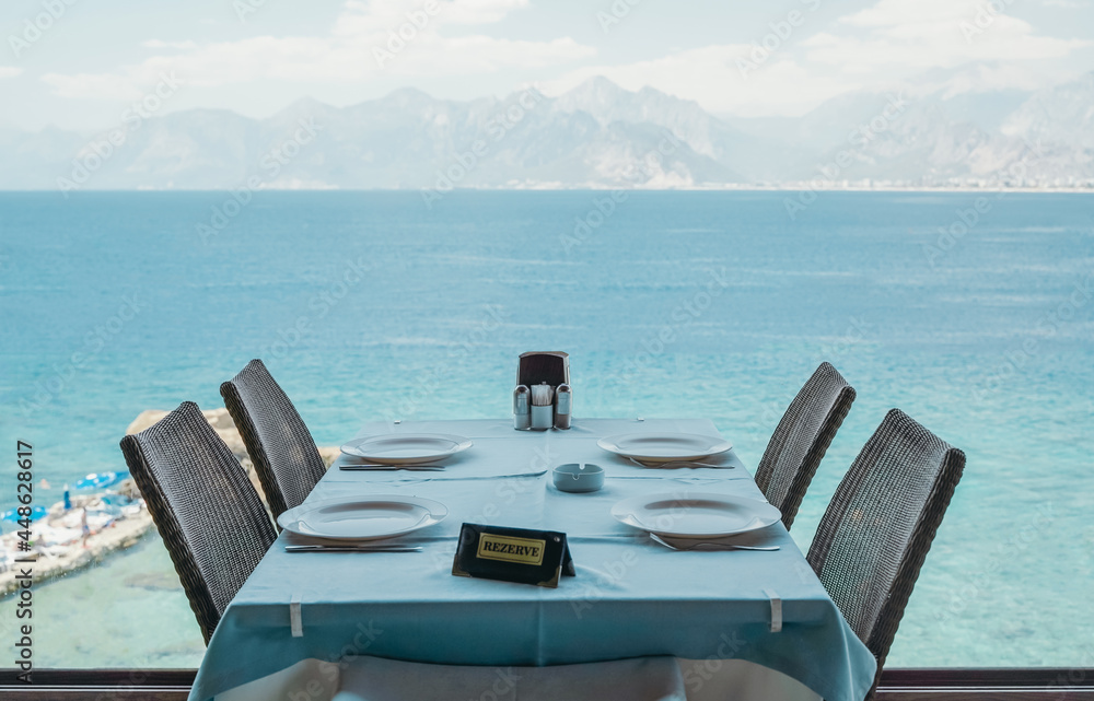 A table in a restaurant or a summer cafe on the sea coast of Antalya, Turkey. Place in a restaurant with a wonderful sea view.