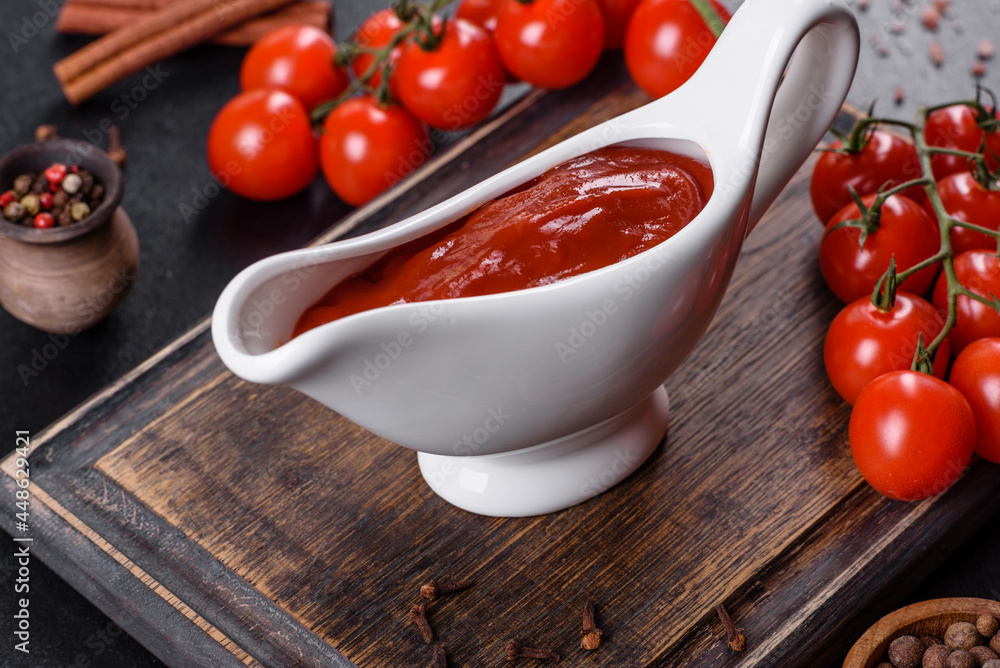 Red sauce or ketchup in a bowl and ingredients for cooking Red sauce or ketchup in a bowl and ingredients for cooking