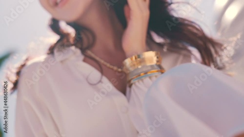 girl with jewelry on the background of the sunny sky