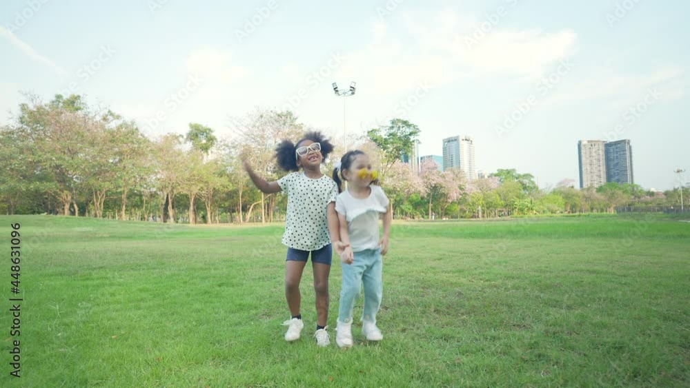 Holiday concept of 4k Resolution. Children jumping happily in the park. Holiday concept of 4k Resolution. Children jumping happily in the park.