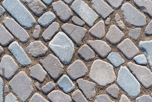 The texture of the paving stones made of natural granite, background.