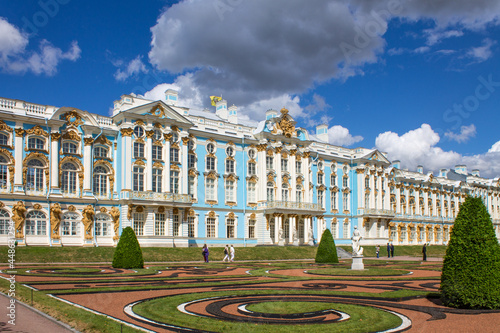 Pushkin, Leningrad Region, Russia - July, 21, 2021: the magnificent blue and white Catherine Palace with beautiful plant beds and trees on a sunny summer day in Tsarskoye Selo