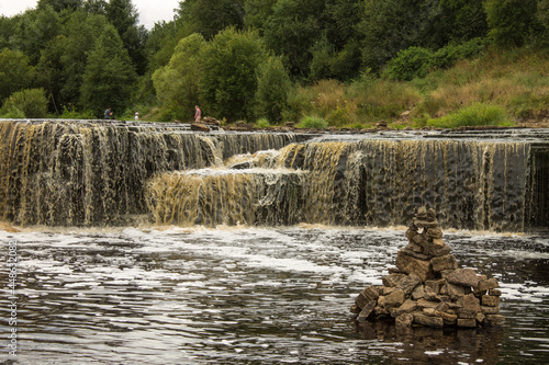 Beautiful Sablinsky waterfall on the Tosna River in the Leningrad region in Russia on a cloudy summer day and a space for copying photo