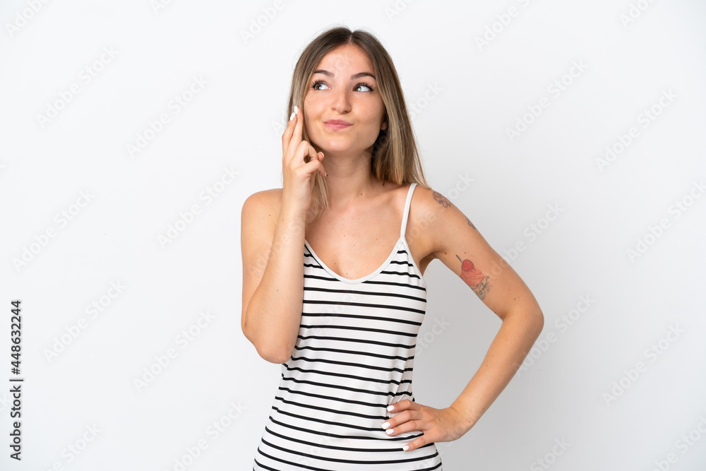 Young Romanian woman isolated on white background with fingers crossing and wishing the best Young Romanian woman isolated on white background with fingers crossing and wishing the best