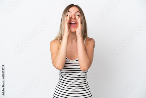 Young Romanian woman isolated on white background shouting and announcing something