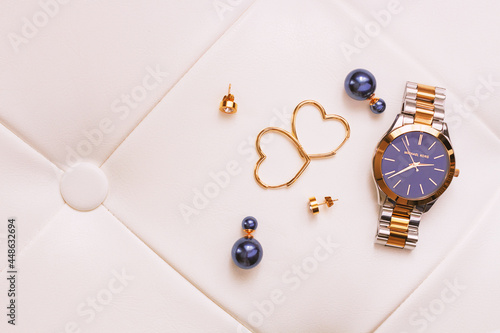 Female gold jewerly and watch complete the stylish look