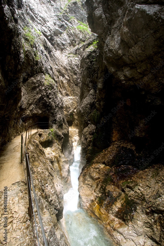 Obraz premium deep gorge with rocks and turquoise white water creek passing