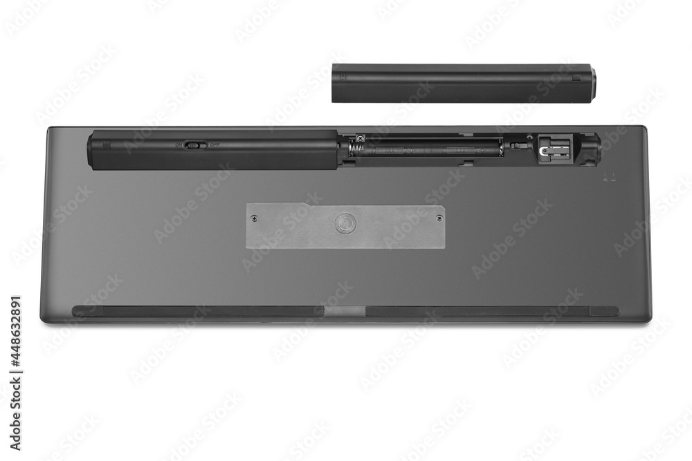 Back view of modern wireless keyboard, showing battery compartment isolated Back view of modern wireless keyboard, showing battery compartment isolated