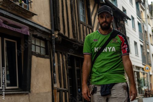 A young tourist at the medieval half-timbered houses in Rennes. Capital of the province of Brittany, France